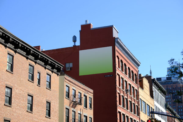 Side view of billboard on a red brick building in Manhattan.