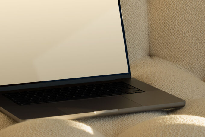 Close-up of MacBook Pro 16" on a couch with sunlight streaming in.