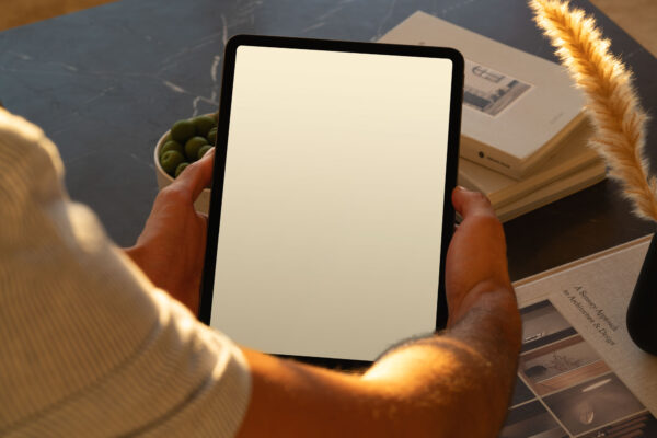 Side view of iPad Pro mockup held in a luxurious apartment.