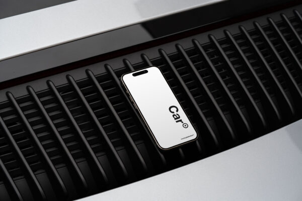 iPhone 15 Pro mockup on a Porsche motor grill.